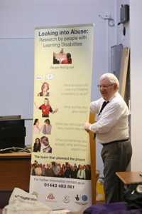 a picture of a researcher showing a banner